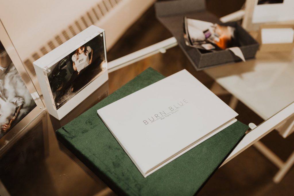 Table display of photo albums and prints.