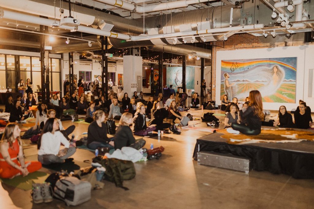 Large group of women sitting and listening to a speaker.