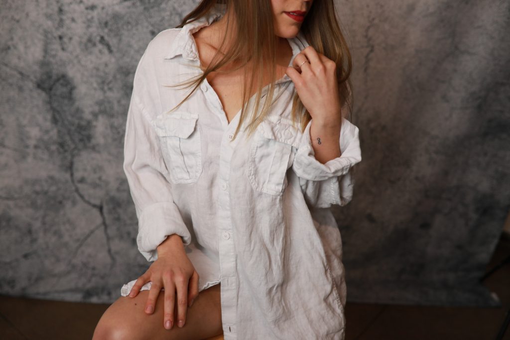 Woman posing in front of a backdrop at a Denver event.