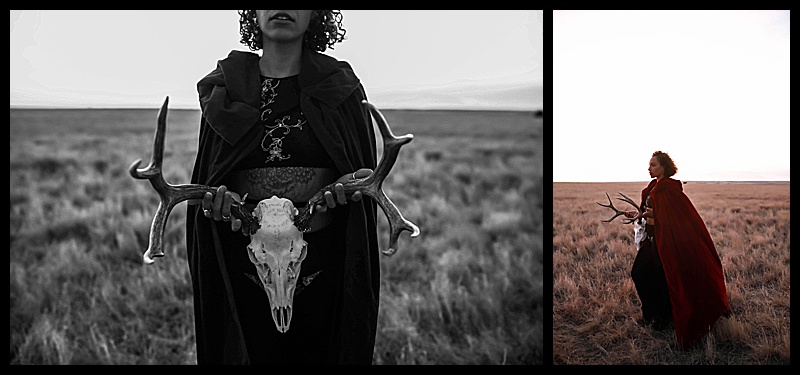 Witchy-women-dressed-in-lingerie-and-cloaks-posing-in-front-of-wooden-structures-in-the-middle-of-a-field