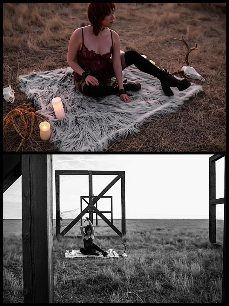 Witchy-women-dressed-in-lingerie-and-cloaks-posing-in-front-of-wooden-structures-in-the-middle-of-a-field