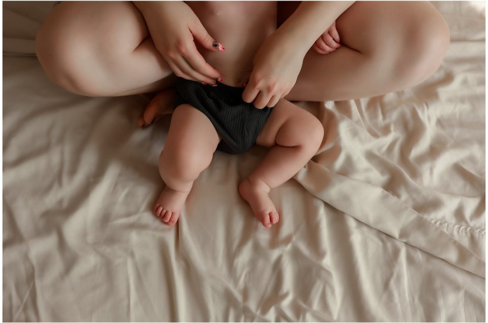 Baby laying in mothers lap.