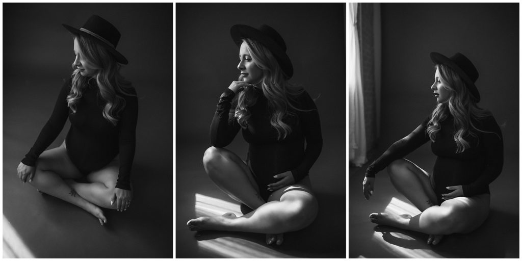 Dark black and white maternity images of woman in hat sitting on floor.