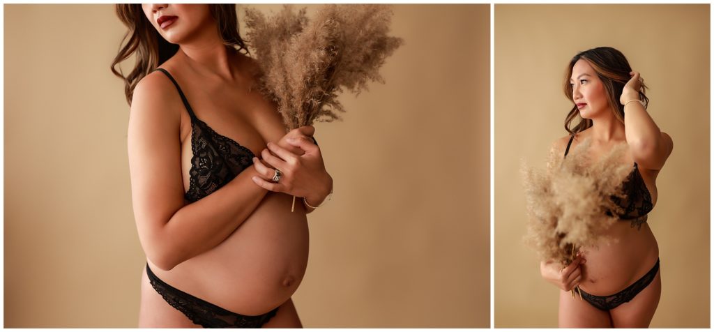 Pregnant woman in black lingerie posing holding pampas grass.