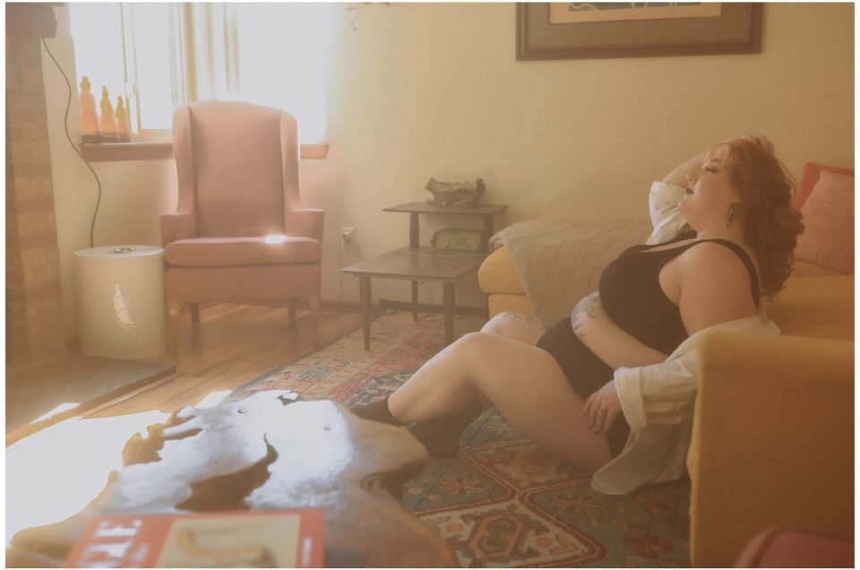 A person lounging on a couch in a warmly lit room with a vintage aesthetic, indulging in a reverie session.
