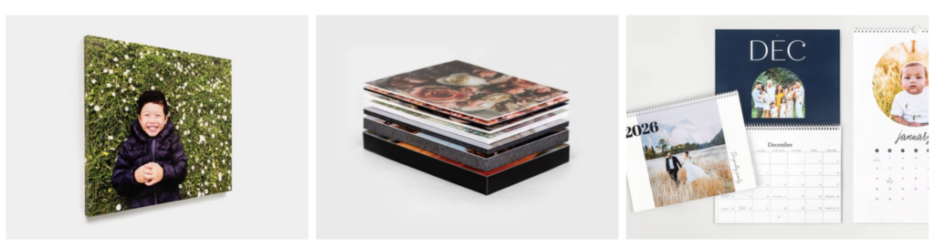 Three photo products: a canvas print of a child on grass, a stack of photo books, and three personalized calendars displayed on a white surface—perfect ideas for the best places to print photos in 2026.