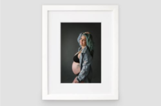 White framed maternity photo.